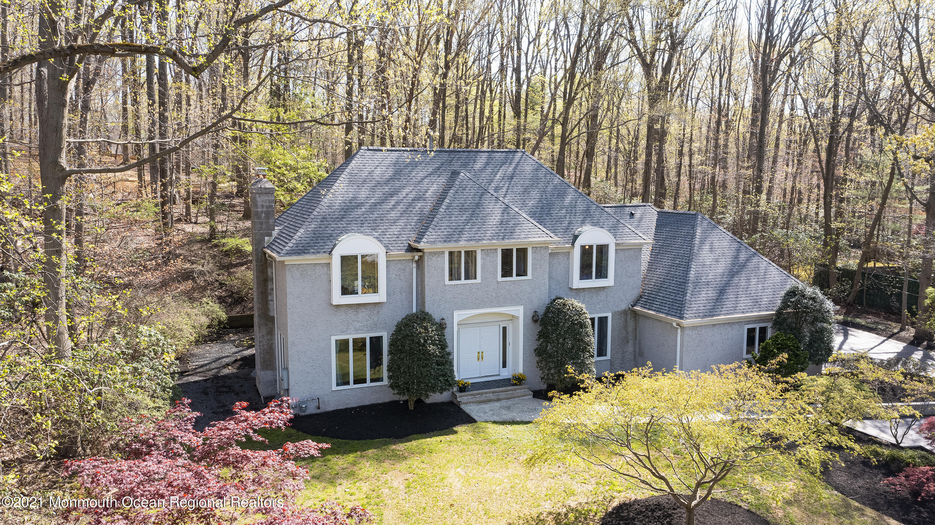 a front view of house with yard covered in snow