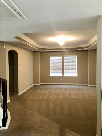 a view of an empty room with window and closet area