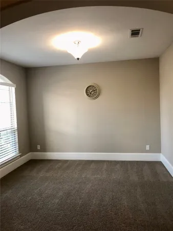 an empty room with a empty space and windows
