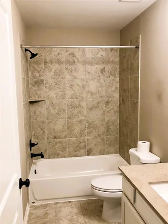 a bathroom with a toilet and a bathtub