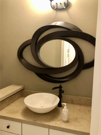 a bathroom with a toilet and mirror