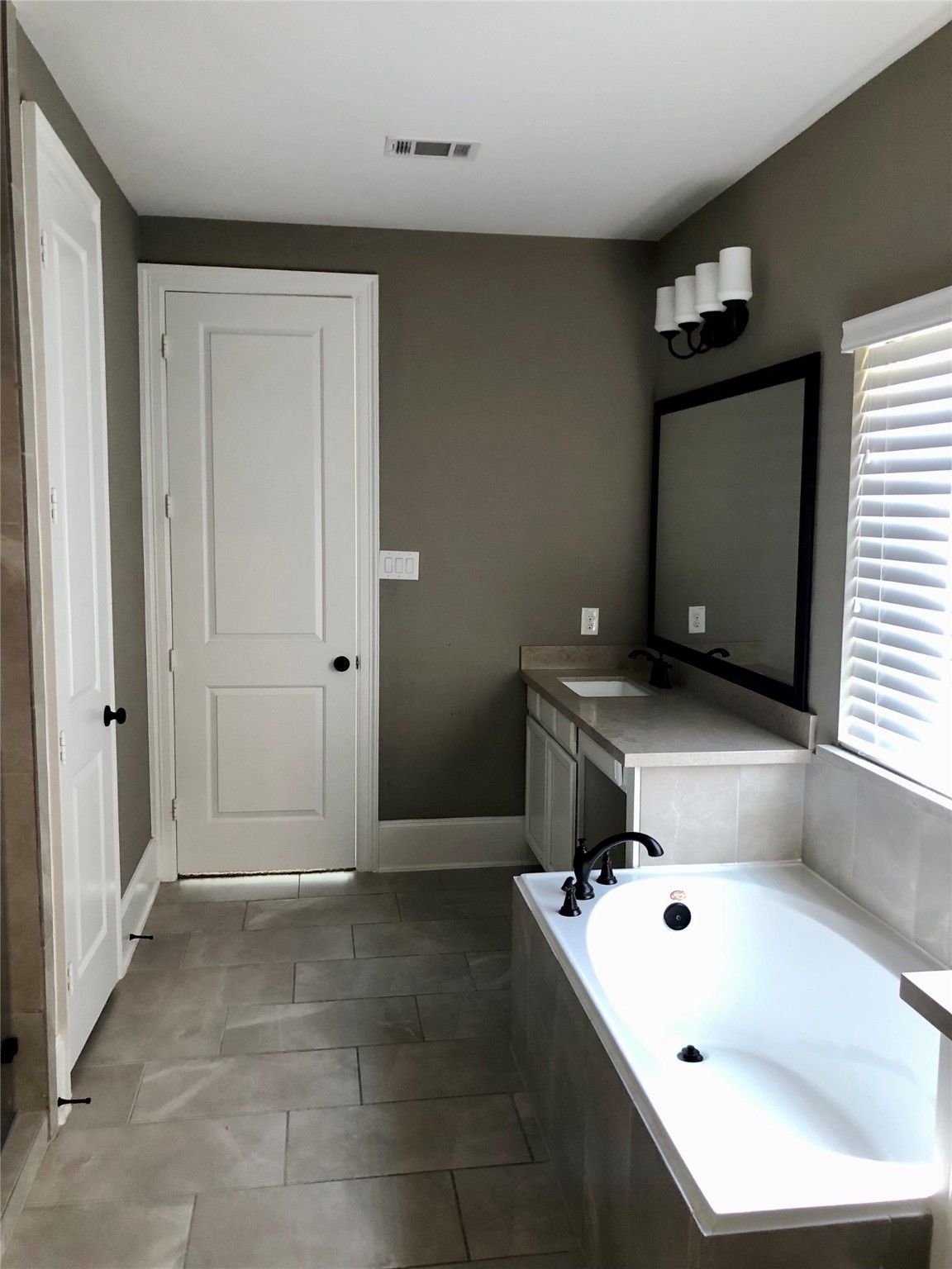 520 Pedernales Street Webster, TX 77598 - Photo 10 of 23 a bathroom with a tub sink and mirror