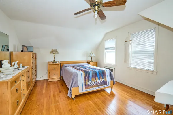 a view of a hallway view with wooden floor and staircase