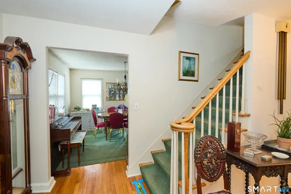 a living room with furniture and a view of kitchen