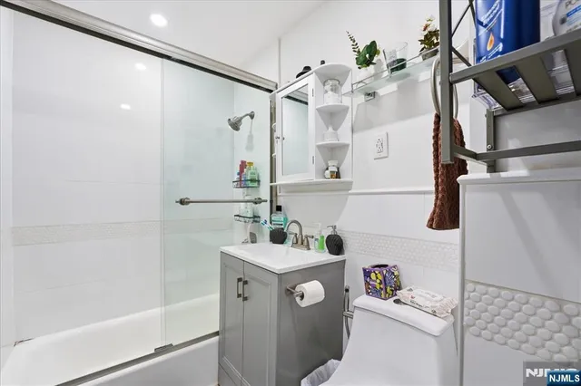 a bathroom with a sink a toilet and shower
