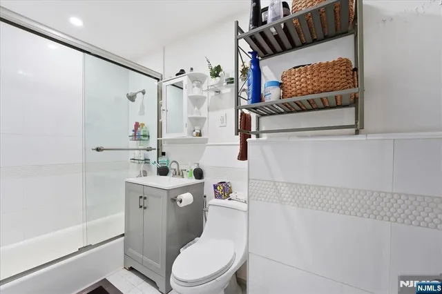 a white toilet sitting next to a bathroom sink and tub