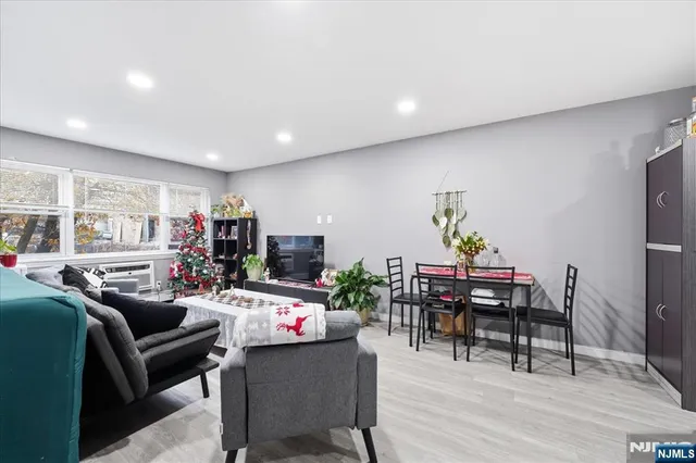 a living room with furniture a dining table and a potted plant
