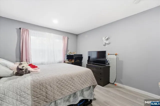 a bedroom with a bed and a tv