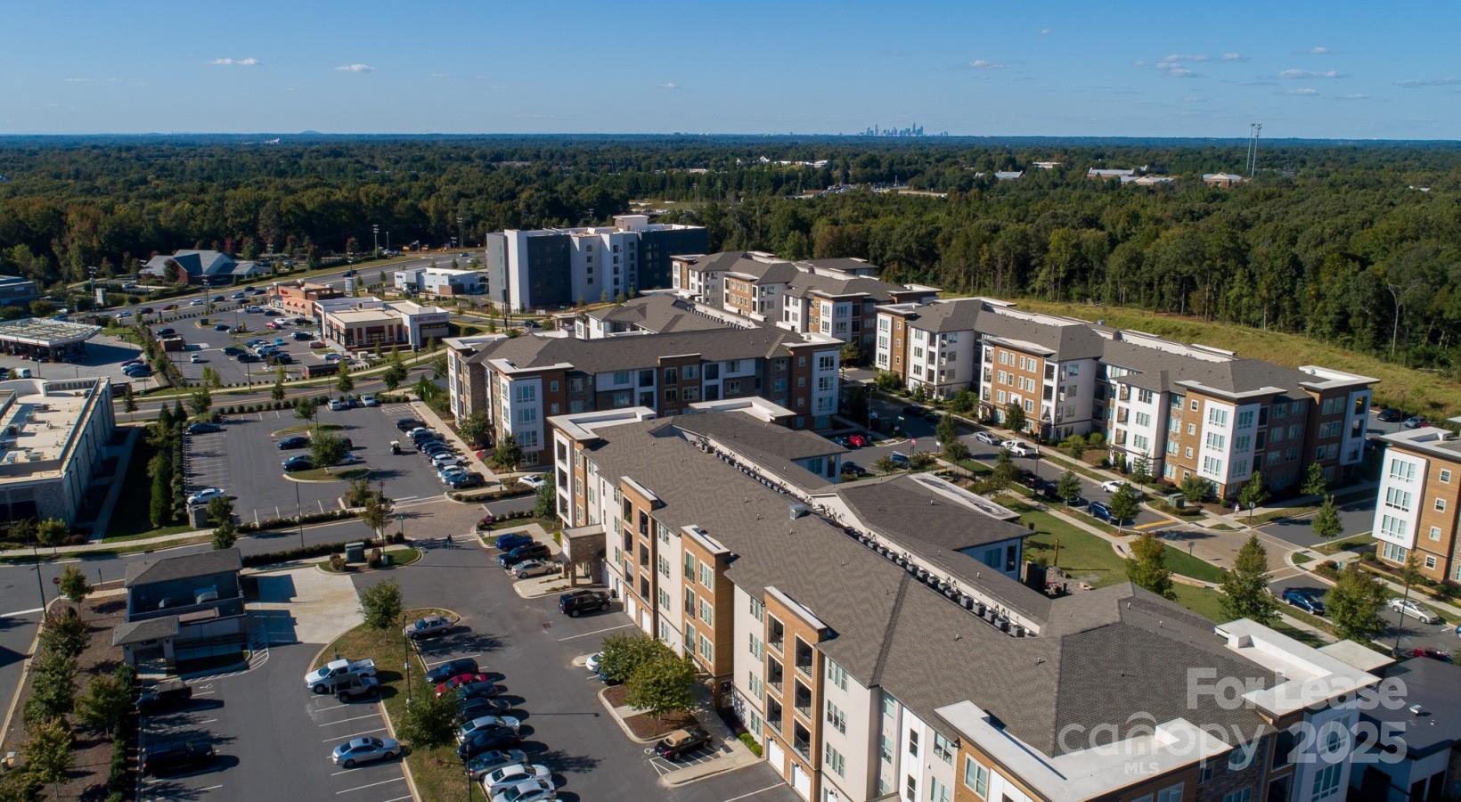 6408 Providence Farm Lane, Unit B2 Charlotte, NC 28277 - Photo 3 of 44 an aerial view of a city with lots of residential buildings