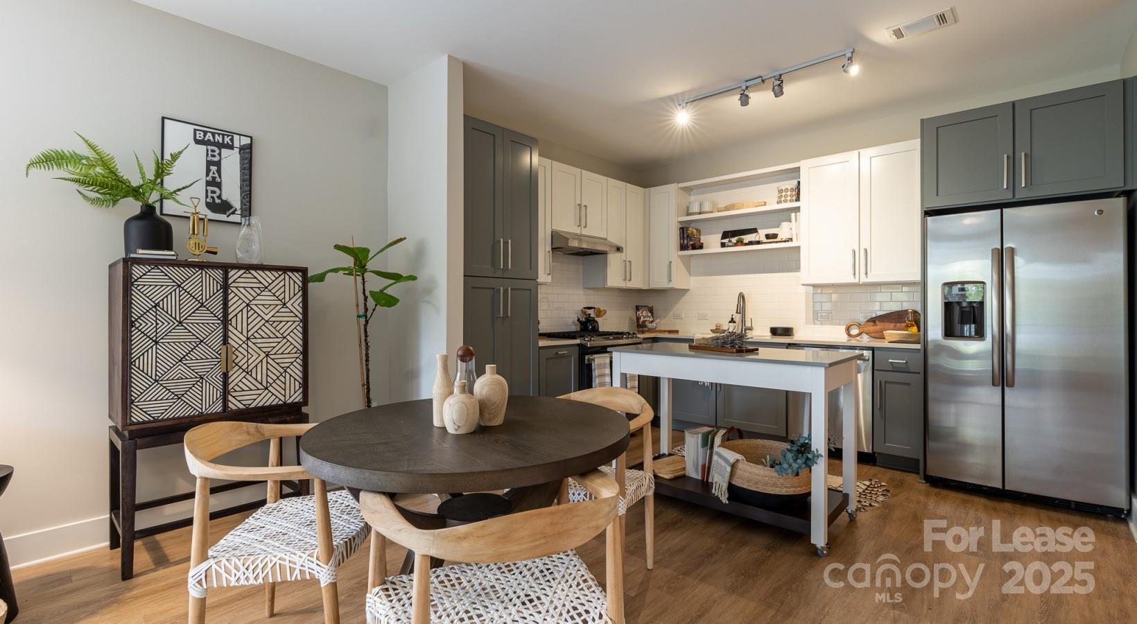 6408 Providence Farm Lane, Unit B2 Charlotte, NC 28277 - Photo 37 of 44 a kitchen with a table chairs a refrigerator and a stove