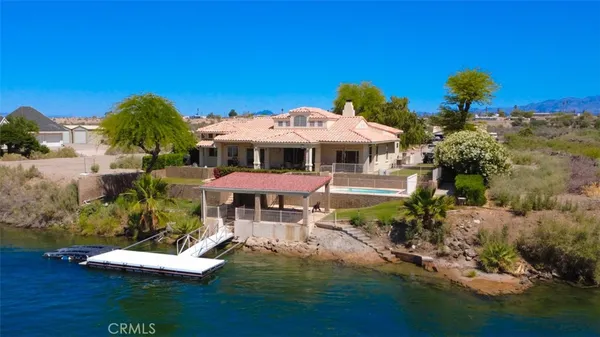 a view of a house with swimming pool and sitting area