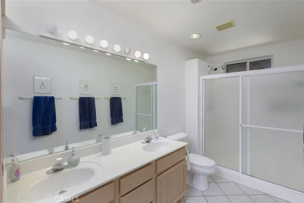 a bathroom with a sink vanity mirror and toilet