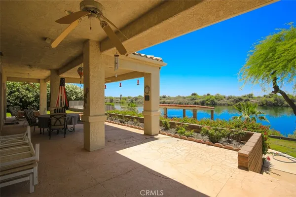 a view of a lake with a table and chairs