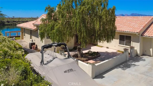 a view of a house with backyard and sitting area