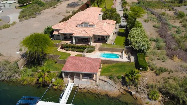 an aerial view of a house with yard swimming pool and outdoor seating