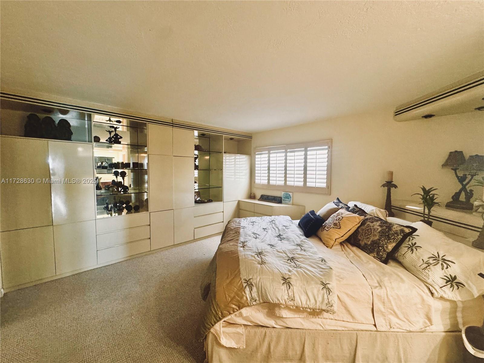 400 North Surf Road, Unit 701 Hollywood, FL 33019 - Photo 13 of 26 a bed sitting in a bedroom next to a window