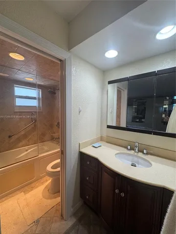 a bathroom with a sink double vanity and a mirror