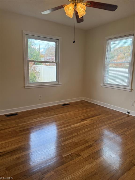 100 Kirk Road Greensboro, NC 27455 - Photo 11 of 42 2nd bedroom with ceiling fan,replacement windows & refinished floors