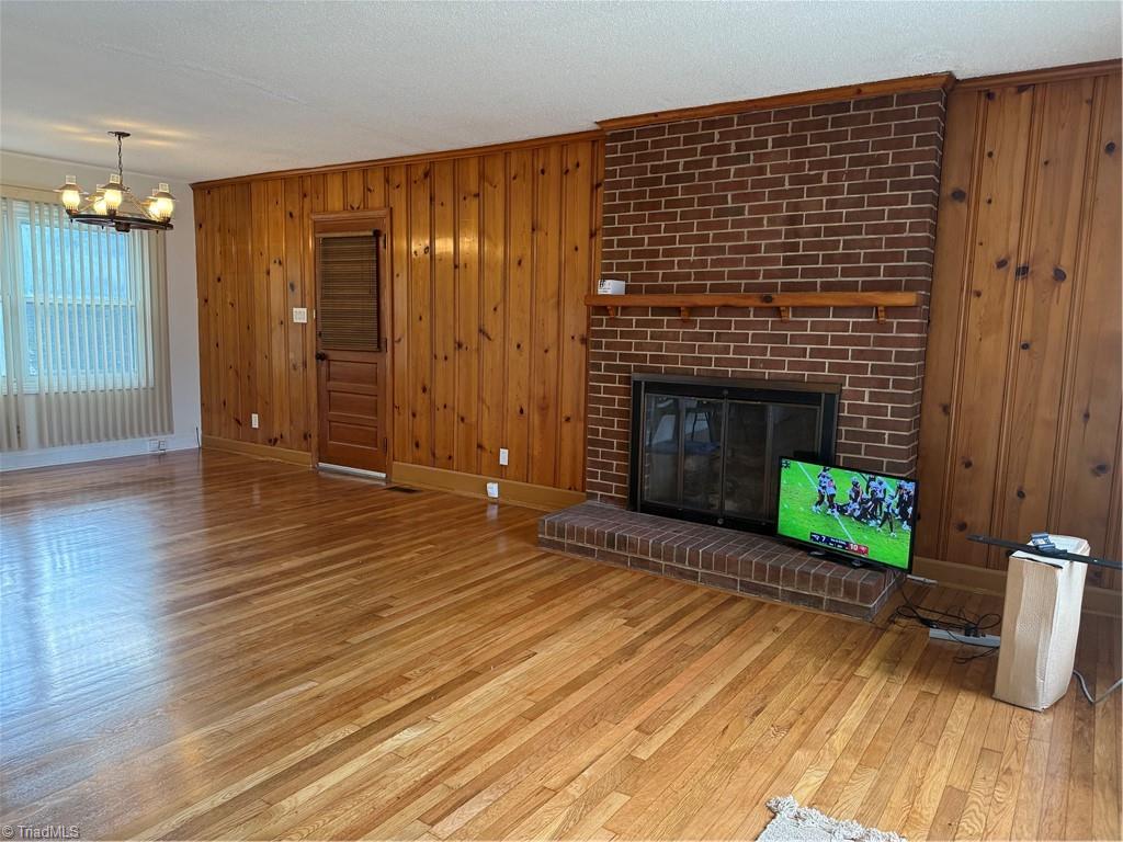 100 Kirk Road Greensboro, NC 27455 - Photo 3 of 42 Vintage knotty pine & brick accent wall with gas logs fireplace .beautiful contrast of all natural materials
