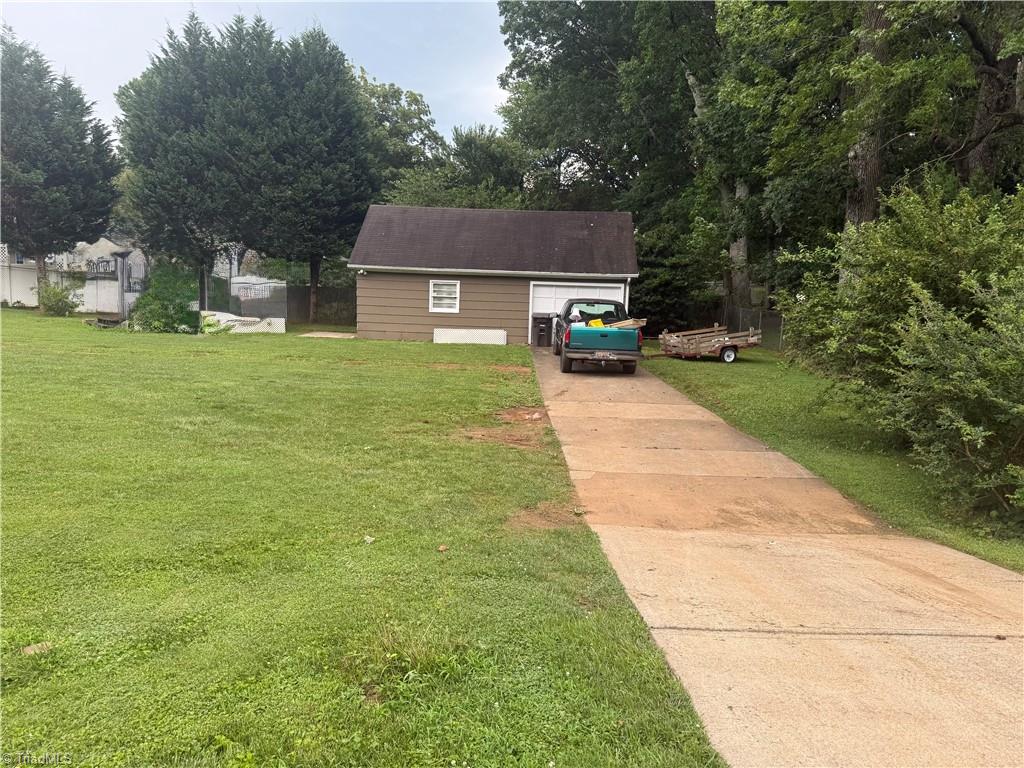 100 Kirk Road Greensboro, NC 27455 - Photo 32 of 42 Driveway off Lawndale to detached garage which has new garage door