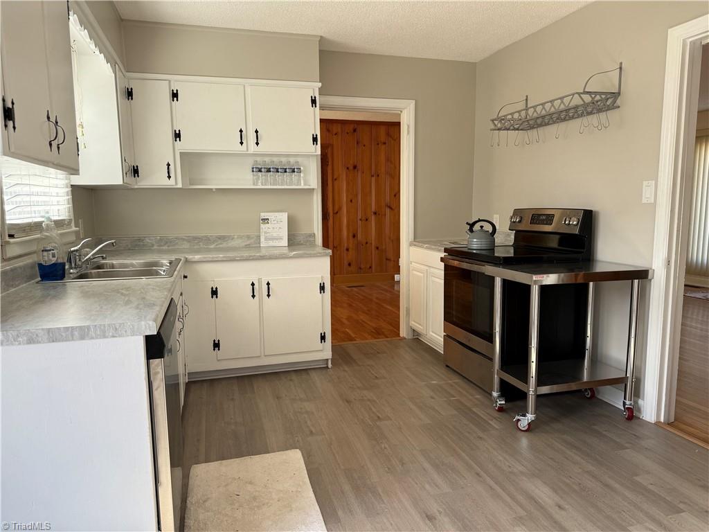 100 Kirk Road Greensboro, NC 27455 - Photo 34 of 42 New counter tops,paint & flooring in kitchen opens to dining area & greatroom