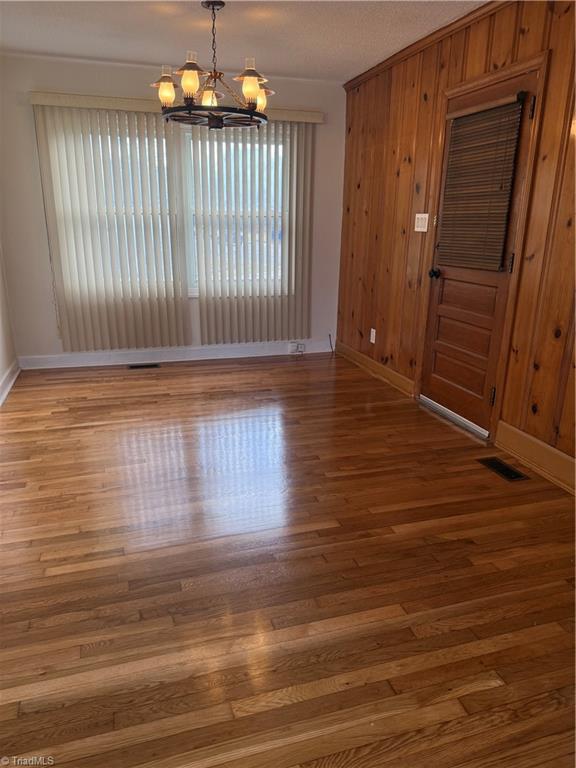 100 Kirk Road Greensboro, NC 27455 - Photo 5 of 42 Great room open to dining area & door to attached garage (laundry connections in garage, cedar closet & wall of windows & tiled floors)