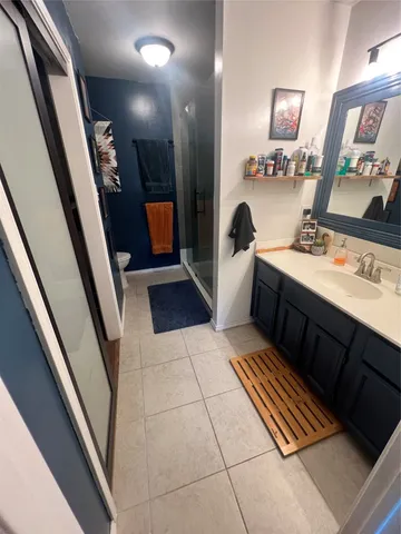 a bathroom with a sink a mirror and a shower