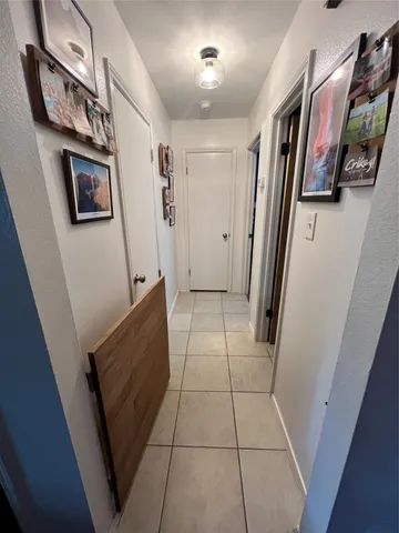 a view of a hallway with paintings on the wall
