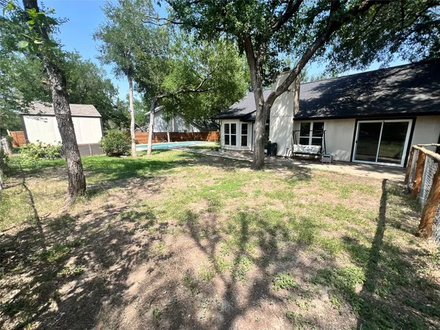a house with trees in the background