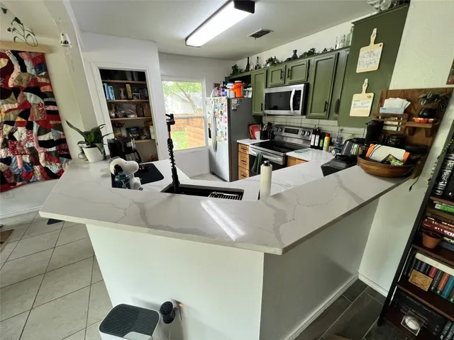 a view of a living room with furniture and a flat screen tv