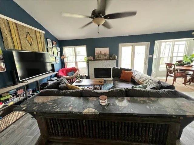 a living room with fireplace furniture and a flat screen tv