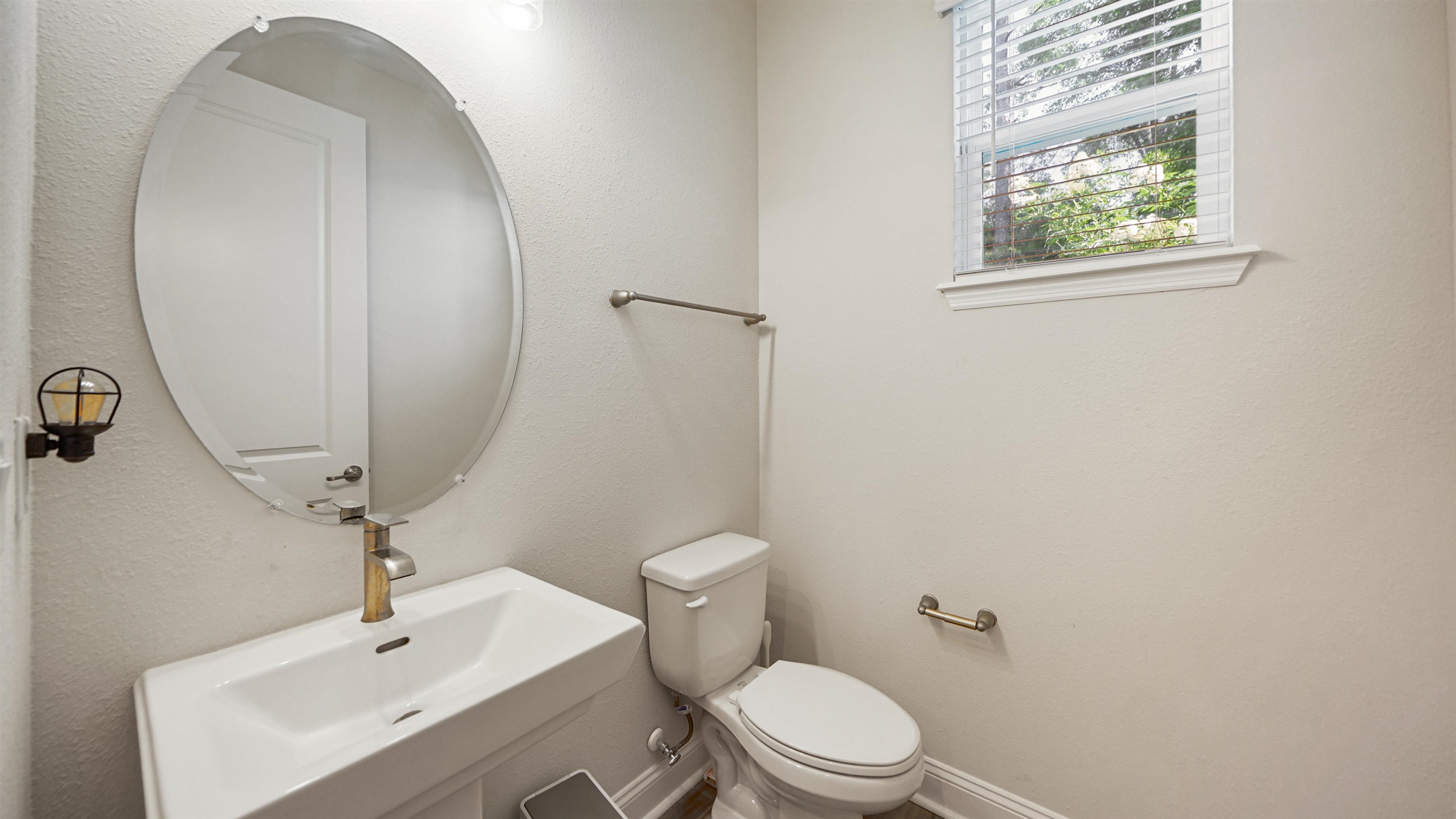 14141 Backbarrier Road Jacksonville, FL 32224 - Photo 11 of 45 a bathroom with a toilet a sink and a mirror
