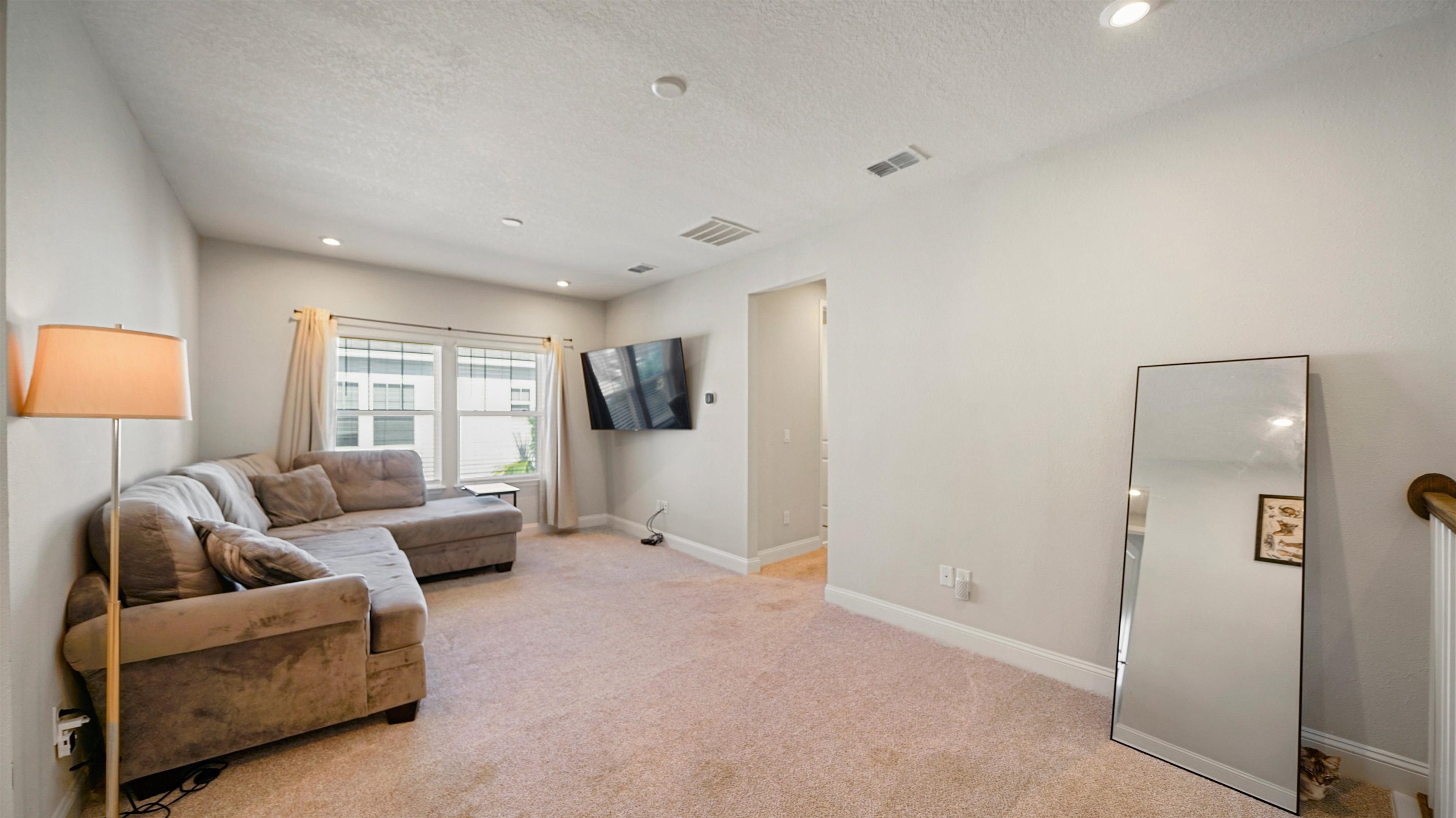 14141 Backbarrier Road Jacksonville, FL 32224 - Photo 13 of 45 a living room with furniture and a large window