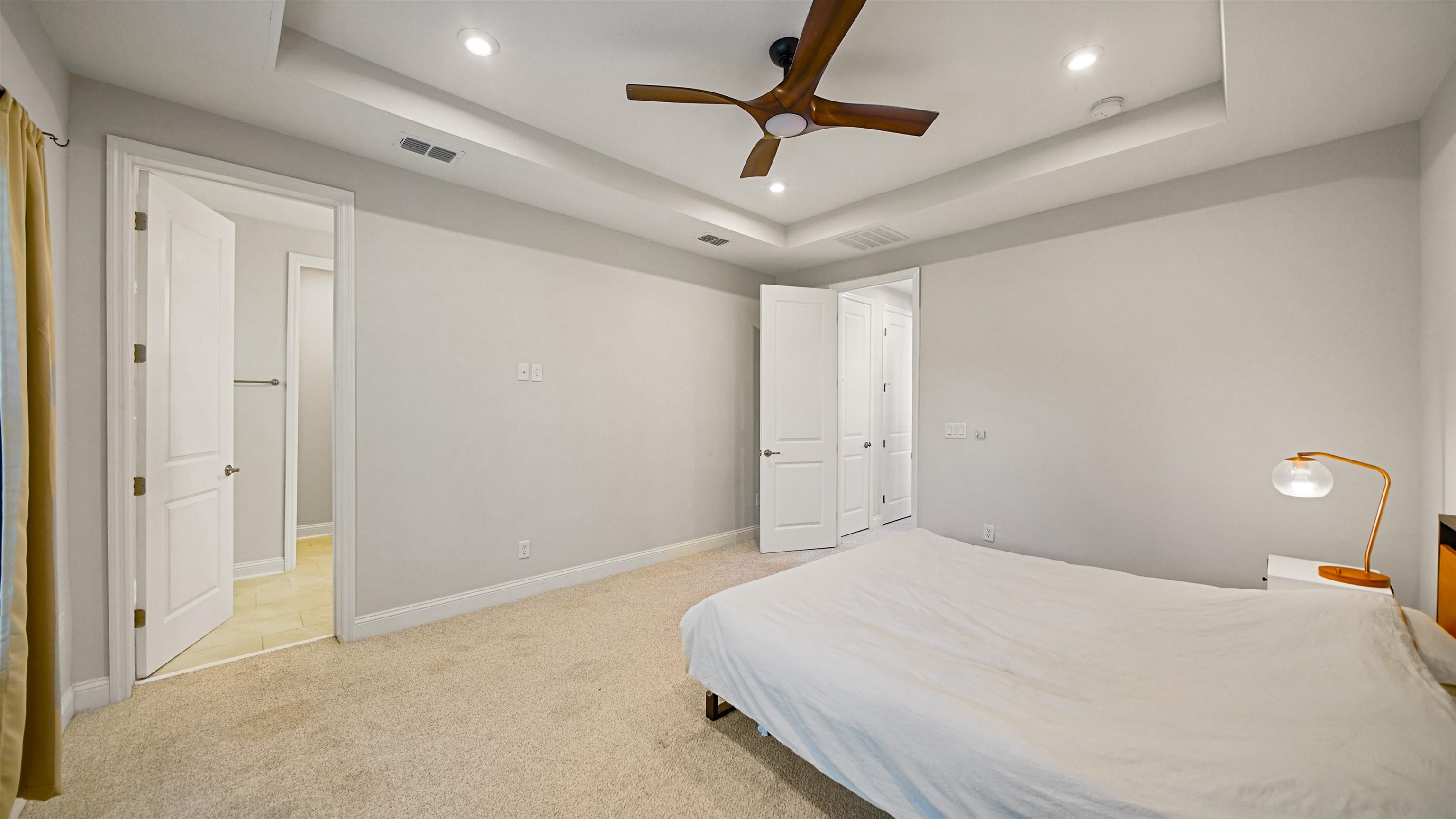 14141 Backbarrier Road Jacksonville, FL 32224 - Photo 16 of 45 a bedroom with a large bed and a chandelier