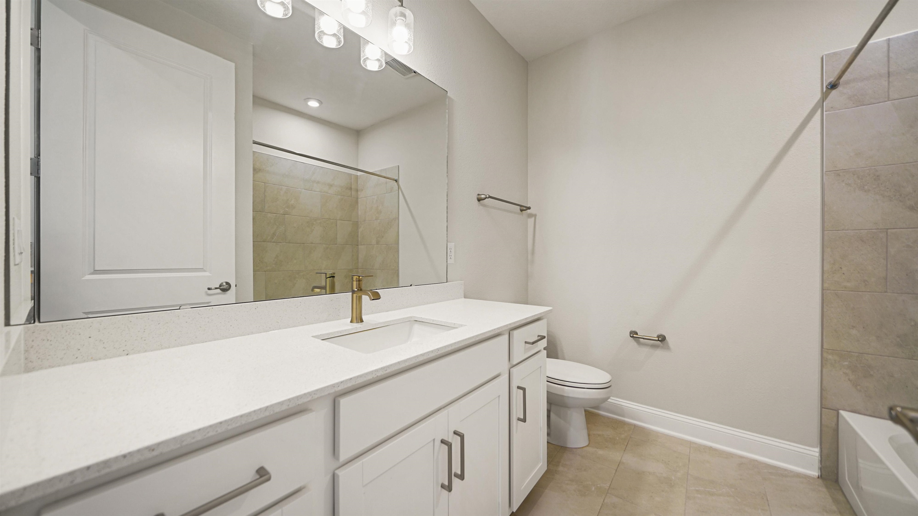 14141 Backbarrier Road Jacksonville, FL 32224 - Photo 21 of 45 a bathroom with a sink a toilet a mirror and vanity