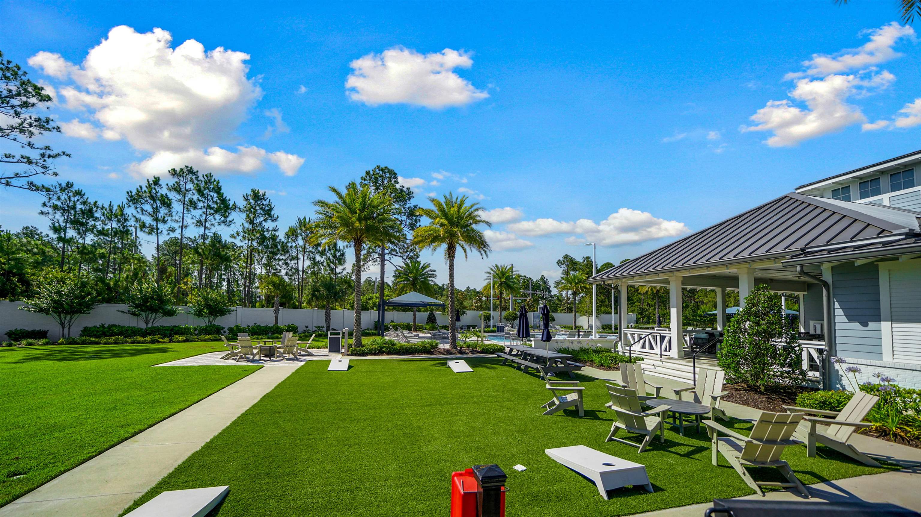 14141 Backbarrier Road Jacksonville, FL 32224 - Photo 39 of 45 a view of a white house with a big yard potted plants and large tree