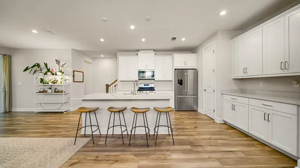 a kitchen with stainless steel appliances granite countertop a refrigerator and a stove top oven