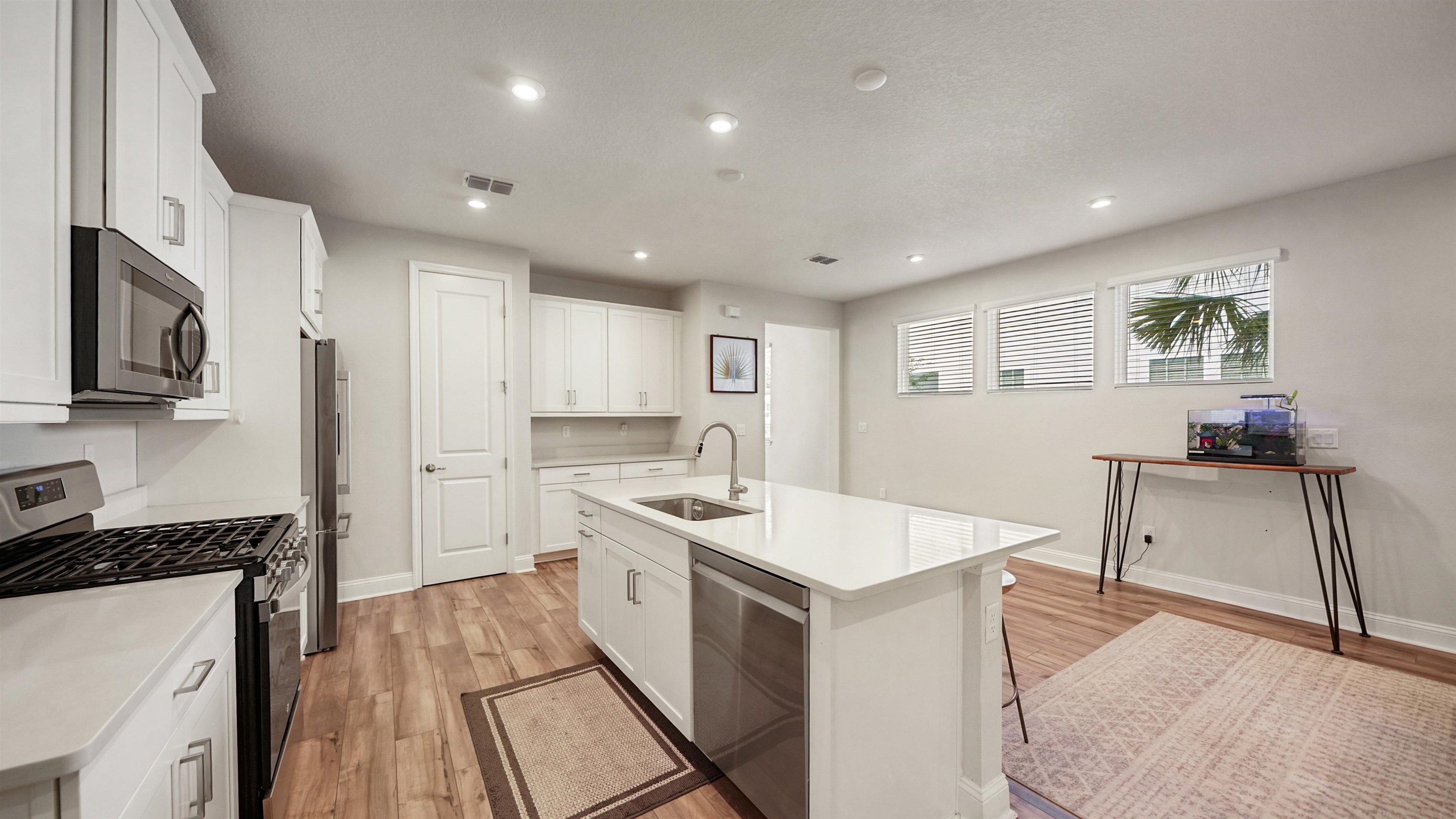 14141 Backbarrier Road Jacksonville, FL 32224 - Photo 7 of 45 a kitchen with a sink stove and cabinets
