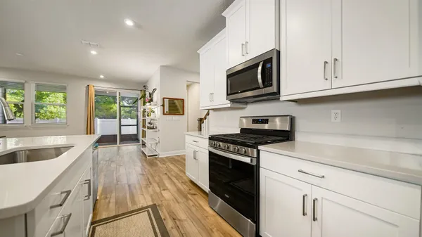 a kitchen with stainless steel appliances granite countertop a sink and a stove