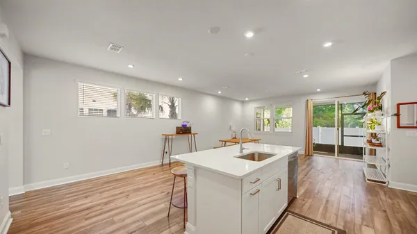 a view of a kitchen with a sink and wooden floor