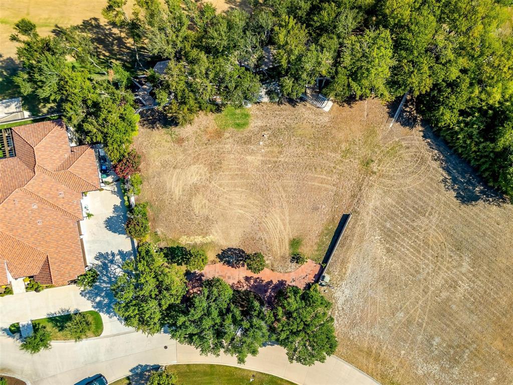 6513 Haig Point Court Fort Worth, TX 76132 - Photo 19 of 37 a view of a yard with plants and a bench