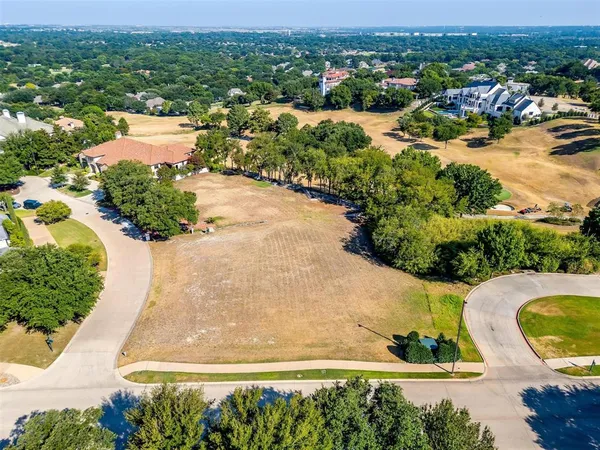 an aerial view of residential houses with outdoor space and swimming pool