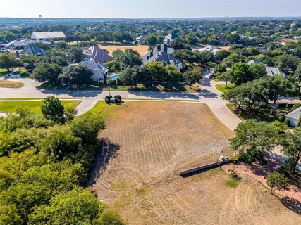 an aerial view of residential houses with yard and swimming pool