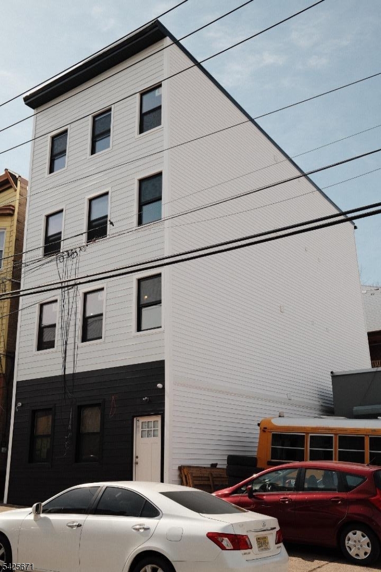 142 Mill Street Paterson, NJ 07501 - Photo 2 of 4 a car parked in front of a building