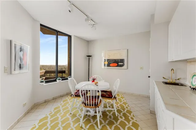 a living room with baby crib furniture and a refrigerator