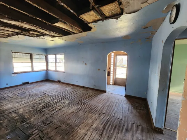 a view of hallway with wooden floor and window