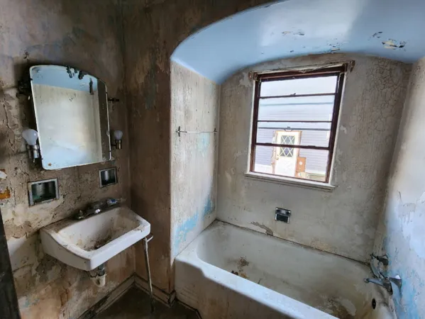 a bathroom with a tub sink and mirror