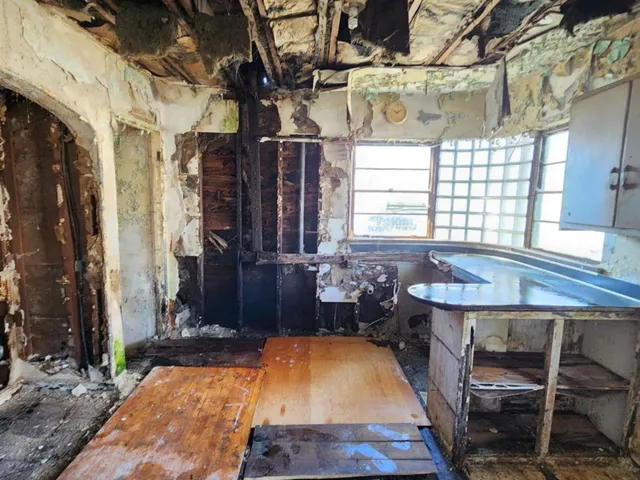 a room with wooden furniture and windows