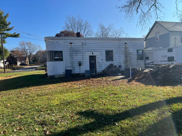 a large pool is sitting in front of the house