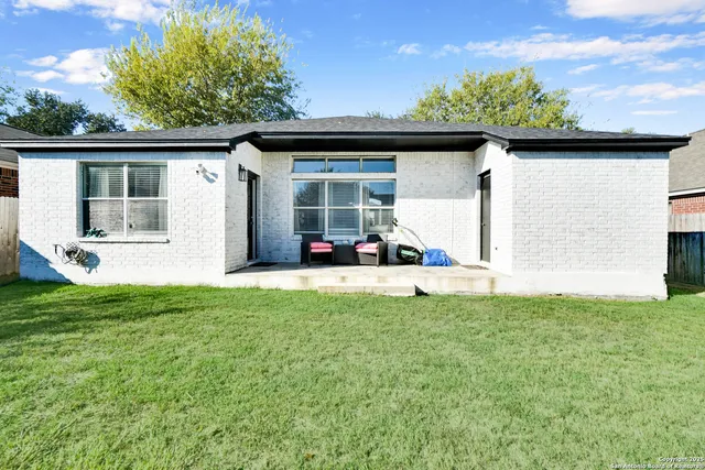 a view of a porch with furniture and a yard
